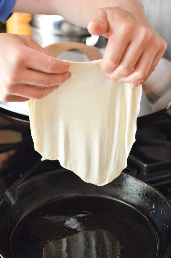 placing thin dough in pan for Jidan Bing, by bmeteor.aiodimecu.cf