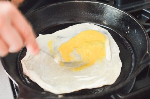stirring raw egg on thin dough in pan for Jidan Bing, by bmeteor.aiodimecu.cf