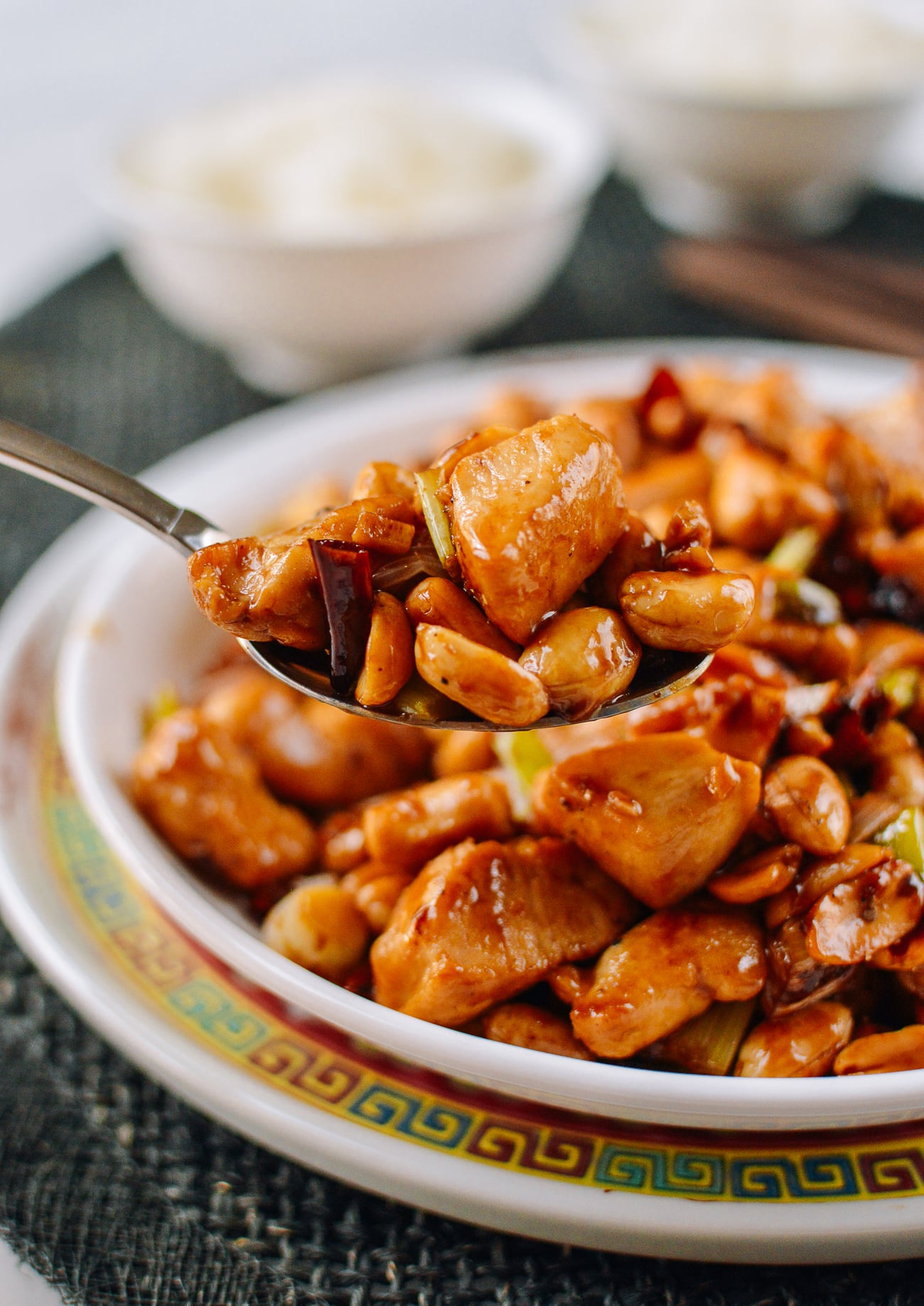 Scoop of kung pao chicken in spoon