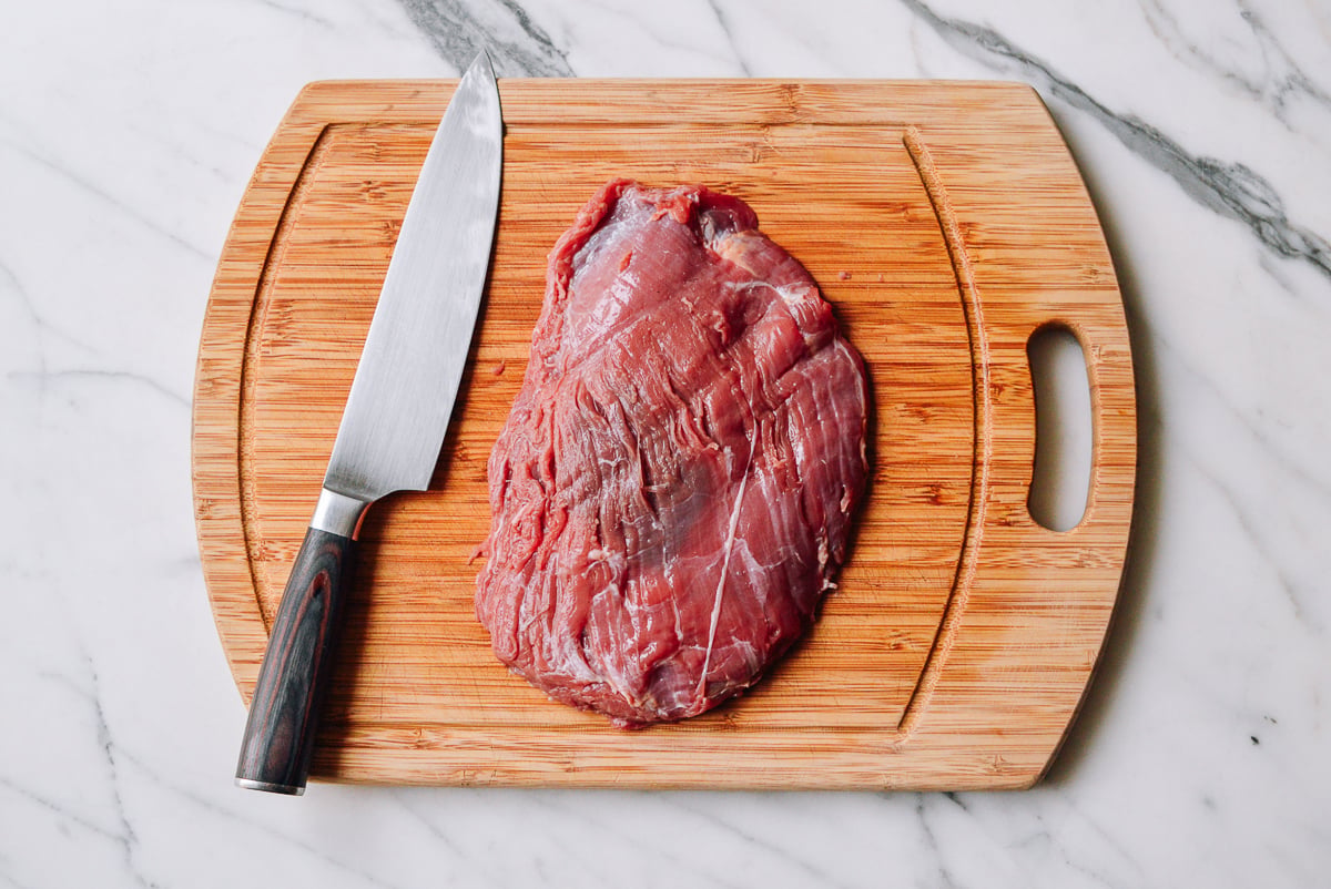 beef flank steak on a cutting board by bmeteor.aiodimecu.cf