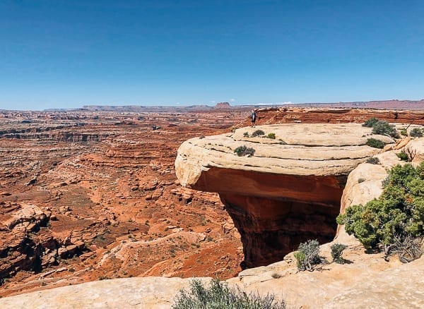 scenic view of hiker near white crack on White rim trail in Canyonlands by bmeteor.aiodimecu.cf
