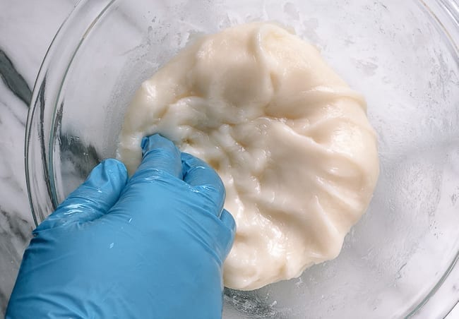 Kneading mochi dough with gloved hands, bmeteor.aiodimecu.cf