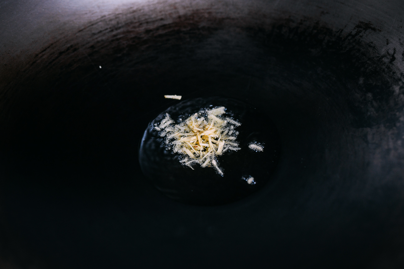 Ginger cooking in oil in wok
