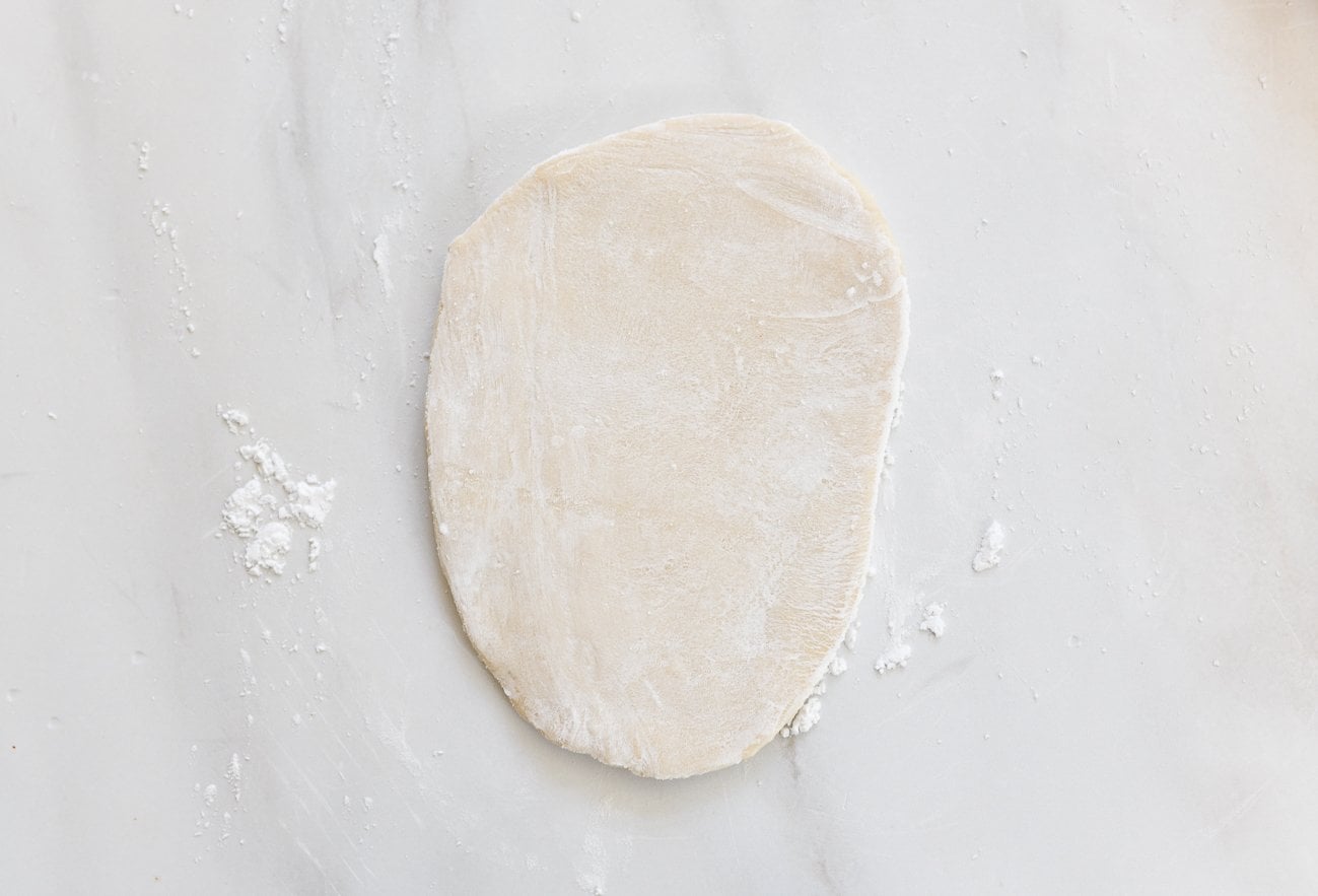 flat piece of dough dusted with cornstarch