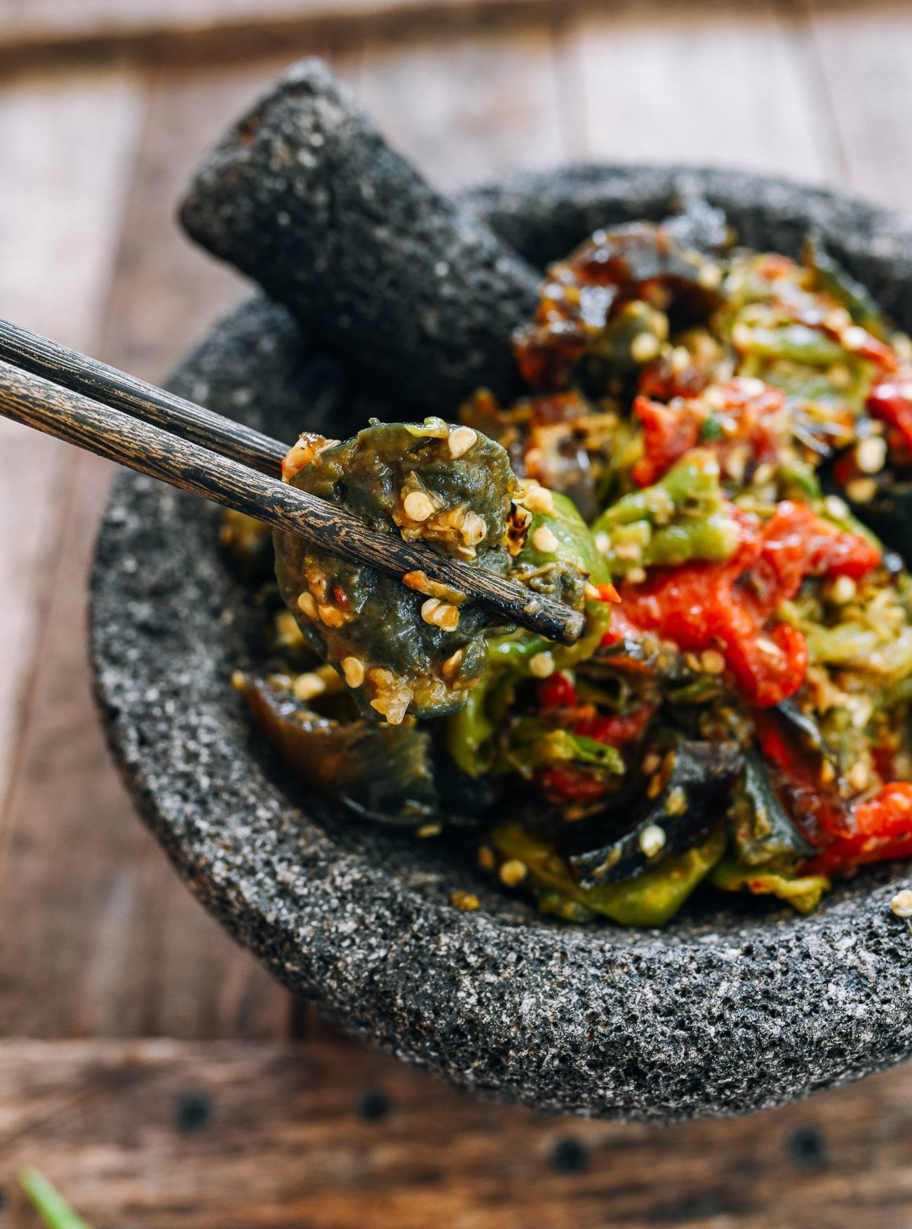 picking up smashed hunan peppers with chopsticks
